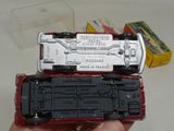 a person holding a toy train in their hand