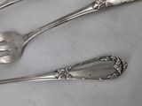 three spoons and a fork sitting on a table