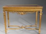 an antique console table with a glass top and gold leaf decoration