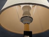 a lamp that has a white shade on top of it