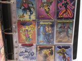 a binder with a bunch of comic books inside of it