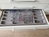 a drawer that has glasses in it and a pair of glasses in it