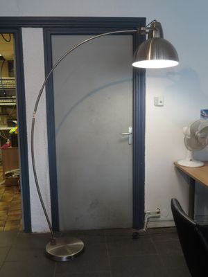 a desk with a lamp and a fan in a room