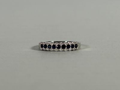 a white gold ring with black and white diamonds