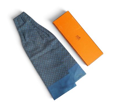 tie and box on a white surface with orange box in the background
