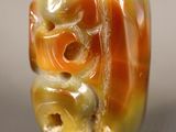 an orange and white bead with a flower design on it