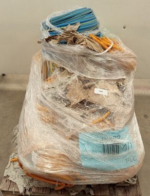a large pile of items wrapped in plastic on a pallet