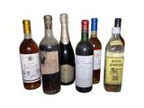 several bottles of wine are lined up on a white surface