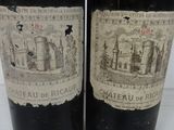 two bottles of red wine are sitting on a table