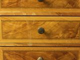 a wooden chest of drawers with three drawers on it