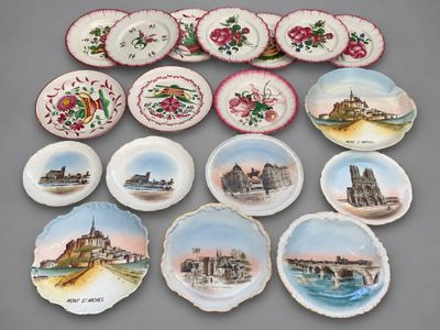 many plates with different designs on them on a table
