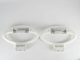 pair of white light fixtures on a white surface