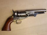 un vieux revolver à crosse en bois posé sur une surface en bois