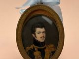a miniature picture of a man in uniform with a blue bow