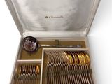 a silver case with silverware in it on a white surface