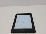 a kindle sitting on a table with the kindle on it
