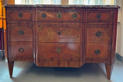 a dresser with a marble top in the middle of a room