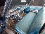 an old car with blue leather seats and a steering wheel