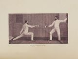 two men that are fencing in a fenced in area