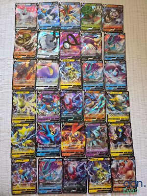 a pile of pokemon cards sitting on top of a table