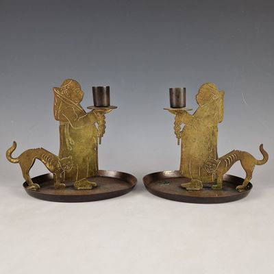 pair of brass figurines of a man and a woman with a dog