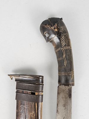 a knife that is next to a lighter on a table