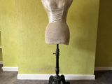 a mannequin sitting on a stand in a room
