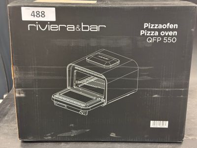 the box of the pizza oven is open on the table