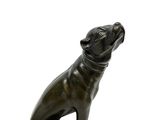 bronze statue of a dog sitting on its hind legs