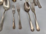 a lot of silver spoons and forks on the table