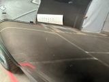 a car parked in a garage with a sign on the back of it