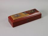 a small wooden box with a painting on it