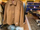a coat hanging on a rack in a clothing store