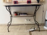 a table with a shelf and a remote control on it