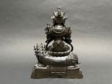 a statue of a woman sitting on top of a turtle
