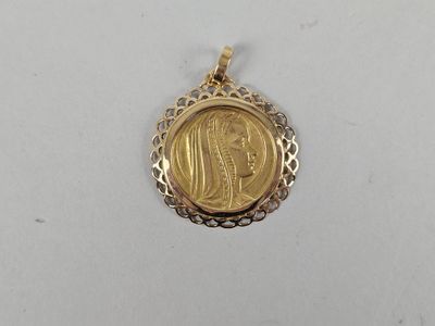 a gold coin pendant with a woman ' s face on it