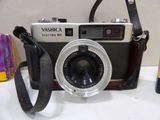a camera sitting on a table with a strap around it