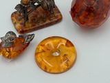 three different pieces of glass and metal on a white surface