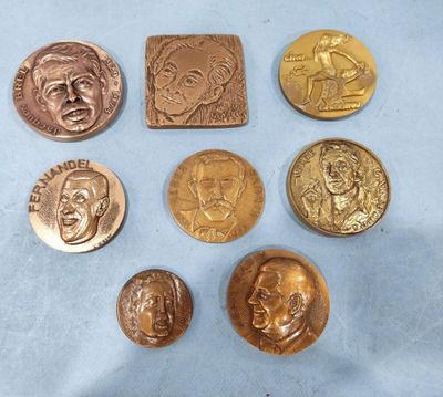 six different types of bronze coins on a blue surface
