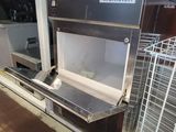 an image of a commercial kitchen with stainless steel shelves and a microwave