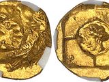 a close up of two gold coins on a white surface