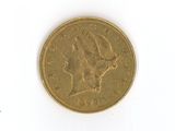 a gold coin on a white surface with a white background