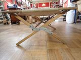 a wooden table with a metal frame on it in a room