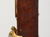 a wooden clock with a dog on it sitting on a table