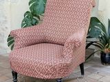 a chair that is sitting in front of a plant