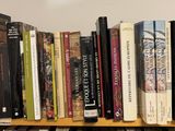 many books that are on a shelf in the room
