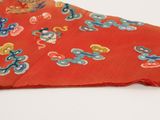 a red jacket with blue and yellow flowers on it