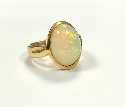 a close up of a ring with a white oplite in it