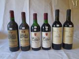 several bottles of wine are lined up on a table