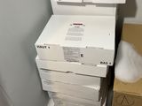 a stack of boxes sitting on the floor next to a wall